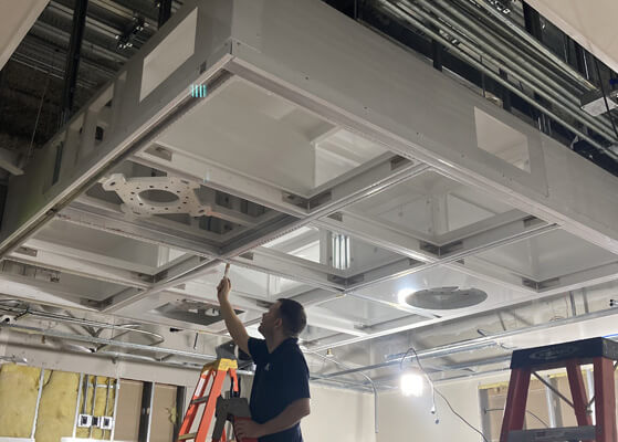 Trautman team member installing HVAC equipment at the UCHealth Anschutz Tower 3